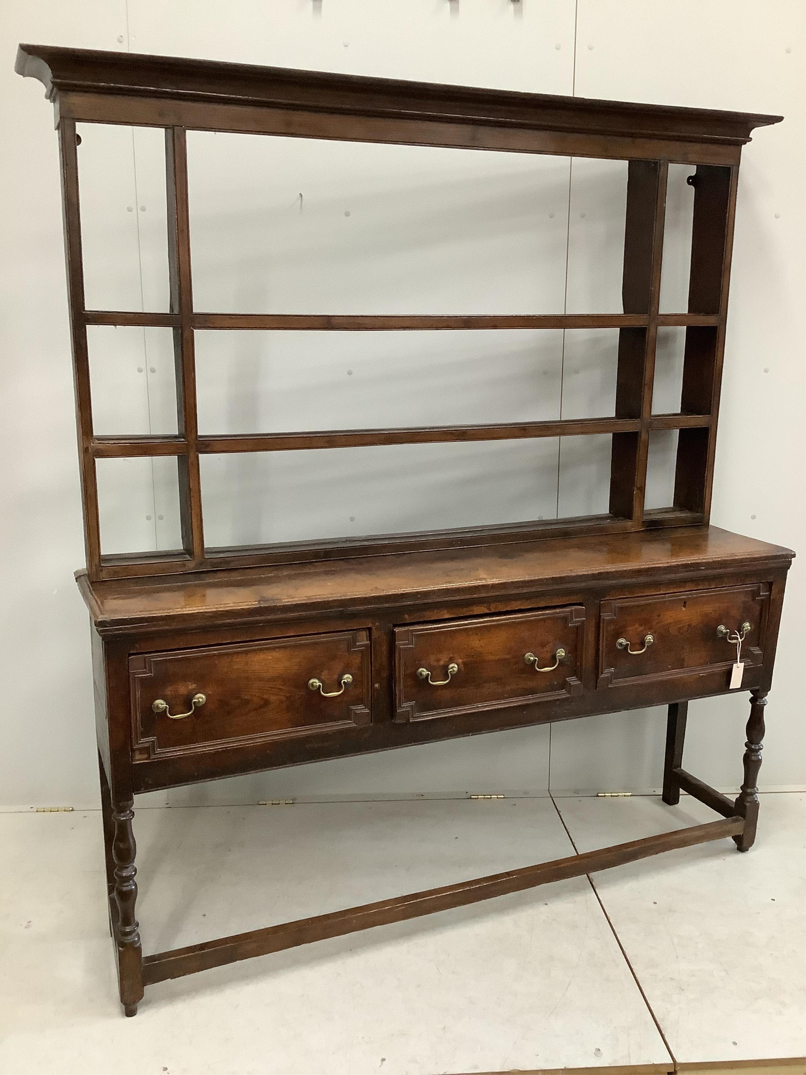 An 18th century oak dresser with open rack, width 176cm, depth 46cm, height 199cm. Condition - fair